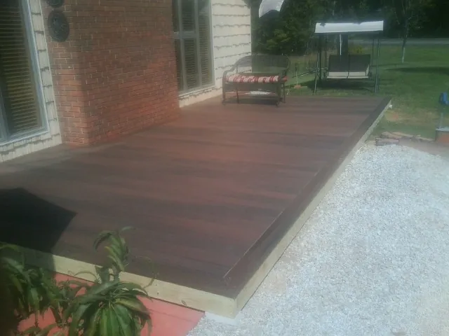 Freshly stained wood deck built against a brick home in Los Alamitos
